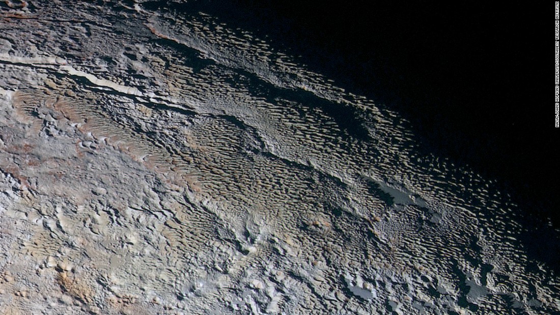 These photos show Pluto&#39;s variety of textures, including what NASA calls &quot;rounded and bizarrely textured mountains.&quot; The mountains are informally called the Tartarus Dorsa. This image shows about 330 miles (530 kilometers) of Pluto&#39;s terrain. It combines blue, red and infrared images taken by the space probe&#39;s Ralph/Multispectral Visual Imaging Camera. The images were taken on July 14, during the probe&#39;s flyby. They were released on September 24. 