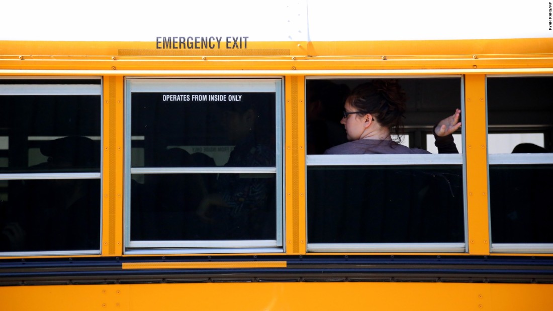 A student waits to walk off a school bus at the fairgrounds on October 1.