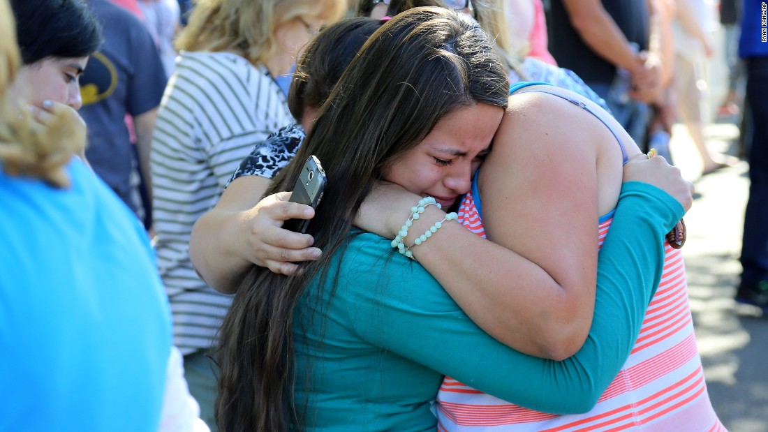 A woman is comforted after the deadly shooting at Umpqua Community College in Roseburg, Oregon, on October 1. Douglas County Sheriff John Hanlin announced at a news conference that the shooter was dead.