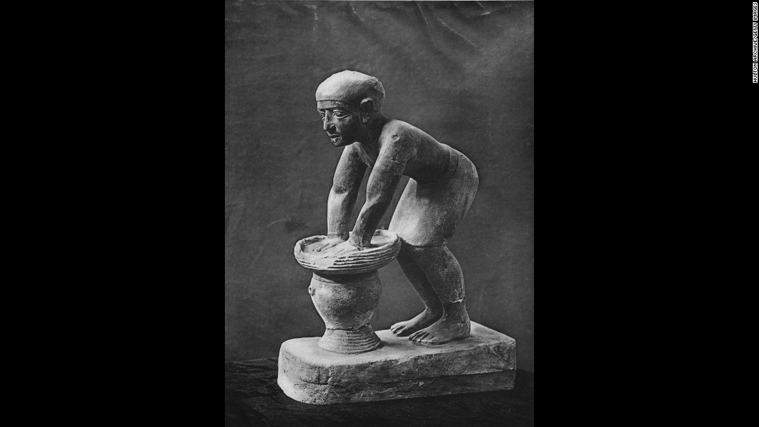 Bread and beer were staple foods in ancient Egypt and Greece. Pictured is a limestone statuette of an Egyptian servant pressing out the fermented barley-bread from which beer was brewed. 