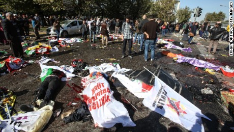 Bodies lay covered with flags and banners at the blast site.