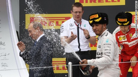 Lewis Hamilton soaks Vladimir Putin in champagne as he celebrates victory at the 2015 Russian GP