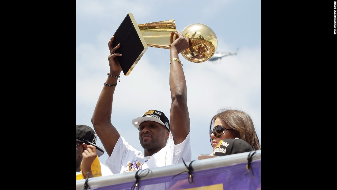 Odom hoists the Larry O&#39;Brien Trophy while riding in the Lakers&#39; victory parade in June 2010. The Lakers defeated the Boston Celtics for a second straight championship.