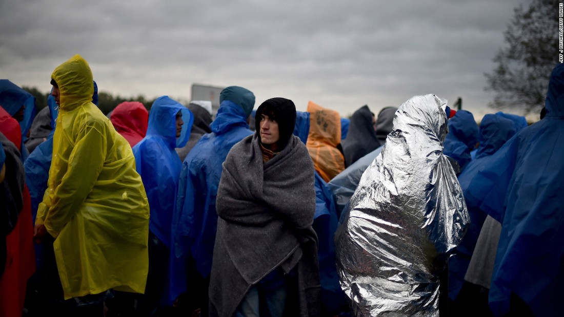 Migrants waited in the rain at the Trnovec border crossing in Croatia on Monday. Amnesty International described the conditions there as &quot;dire.&quot;