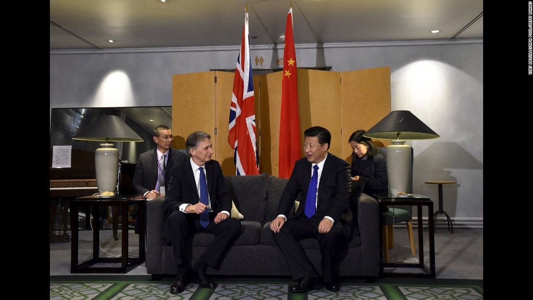 British Foreign Secretary Philip Hammond sits with Xi at Heathrow Airport after Xi&#39;s arrival on Monday, October 19.
