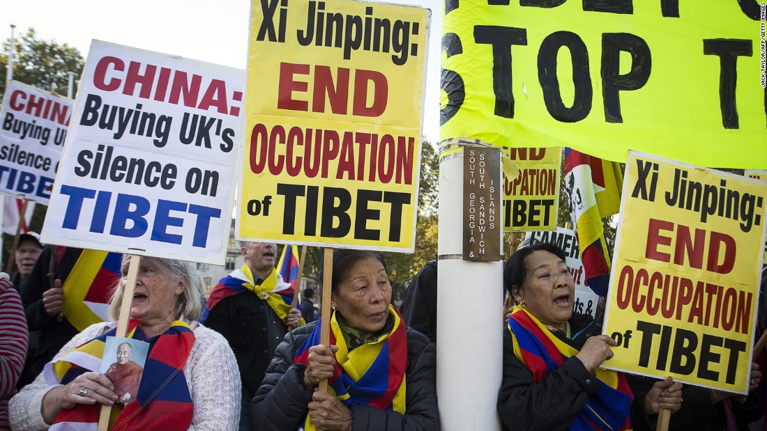 Pro-Tibet protesters hold placards and chant slogans as they demonstrate on Parliament Square in London on October 20.