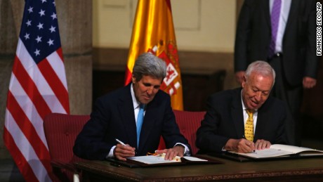 U.S. Secretary of State John Kerry, left, and Spanish Foreign Minister Jose Manuel Garcia Margallo sign agreements Monday, October 19, relating to the cleanup of the Palomares disaster of 1966.