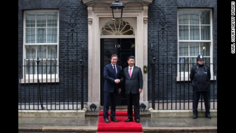 Britain&#39;s Prime Minister David Cameron greets Xi as he arrives at 10 Downing Street.