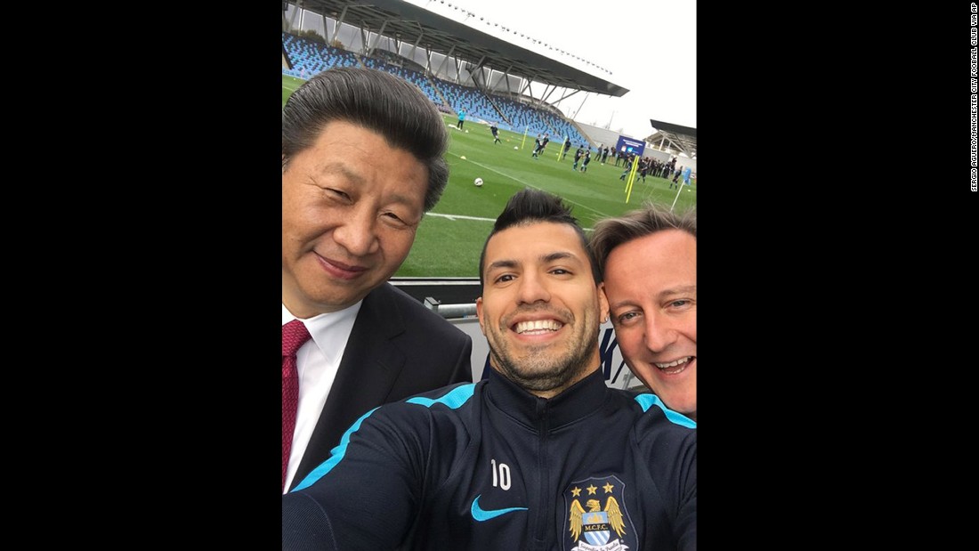 Manchester City soccer player Sergio Aguero takes a selfie with Xi and Cameron during a visit to the soccer club&#39;s practice session on October 23.