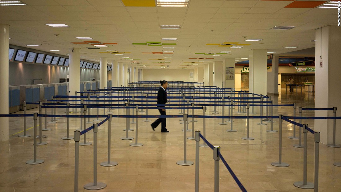 An airline employee walks around the empty airport in Puerto Vallarta, where all flights were canceled on October 23.