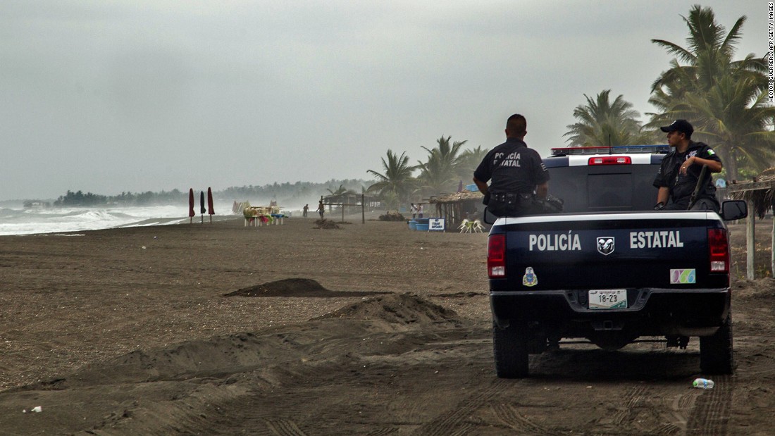 Police patrol the beach in Boca de Pascuales on October 22.