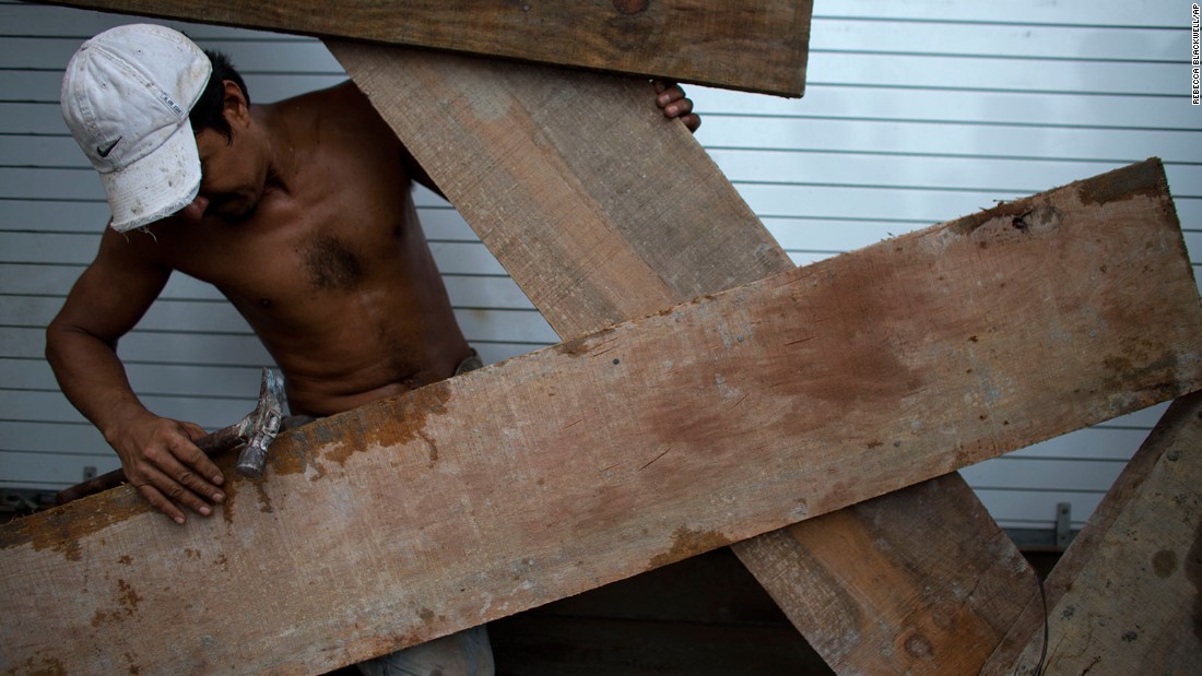 A man boards up a waterfront business in Puerto Vallarta on October 23.