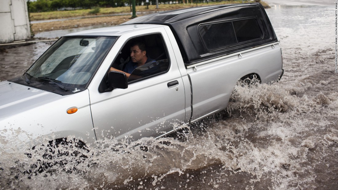 A truck driver braves a flooded street leading into Tecomán, Colima state. 