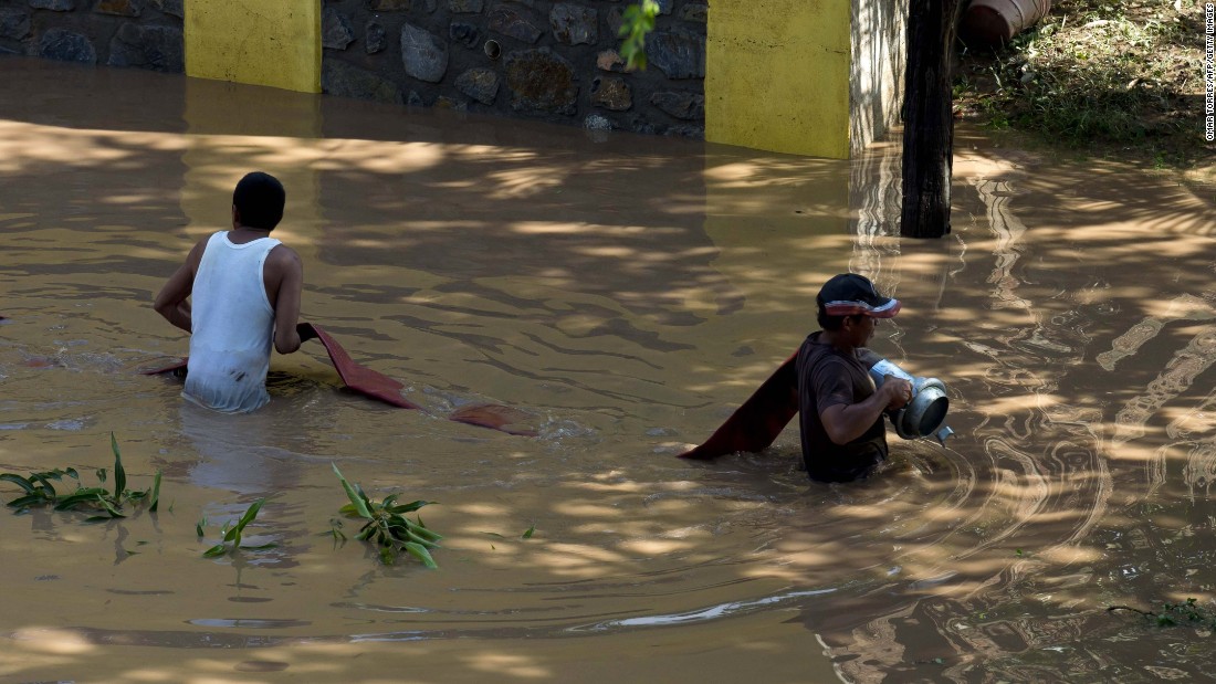 Firefighters set a line to pump water out from a flooded area in Cihuatlan, Mexico, on October 24.  