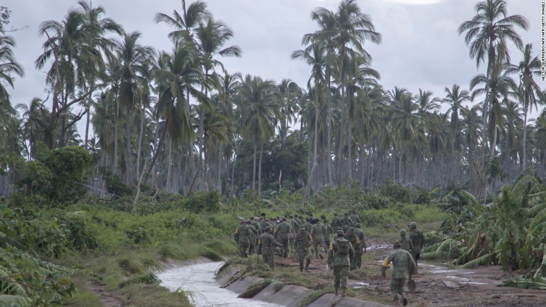 Mexican soldiers patrol looking for people in need of help in the El Rebalse community in Jalisco state, Mexico, on October 24.