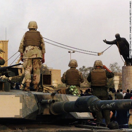 BAGHDAD, IRAQ - APRIL 9:  (FILE PHOTO)  U.S marines and Iraqis are seen on April 9, 2003 as the statue of Iraqi dictator Saddam Hussein is toppled at al-Fardous square in Baghdad, Iraq.  The third year anniversary since the overthrow of Saddam Hussein will be marked on April 9, 2006 amidst continued unrest in Iraq, where over 30, 000 civilians have been reported to be killed since the start of the war. (Photo by Wathiq Khuzaie /Getty Images)