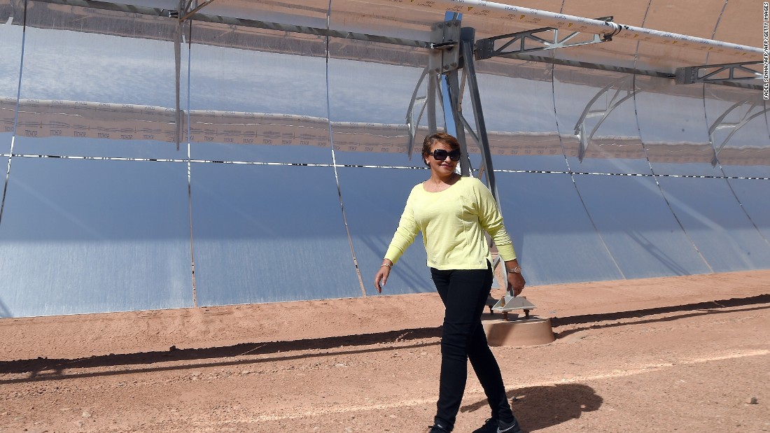 Morocco&#39;s environment minister Hakima El Haite walks in front of a solar array that is part of the Noor 1 solar power plant, which is due to  start operating in a few weeks. 