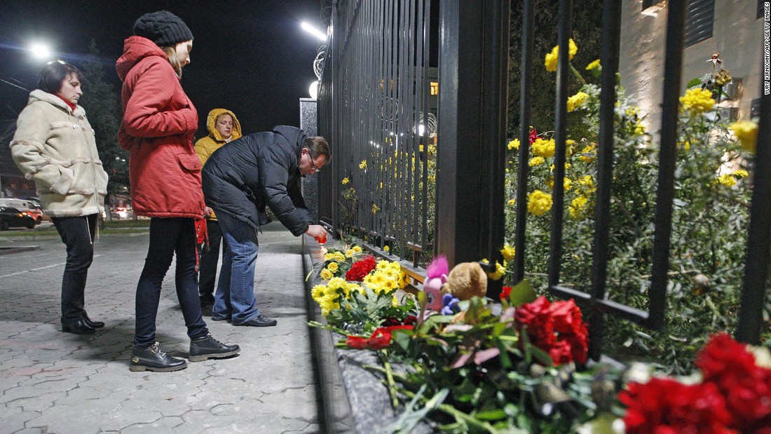 People light candles and leave flowers at the Russian Embassy in Kiev, Ukraine, on October 31.