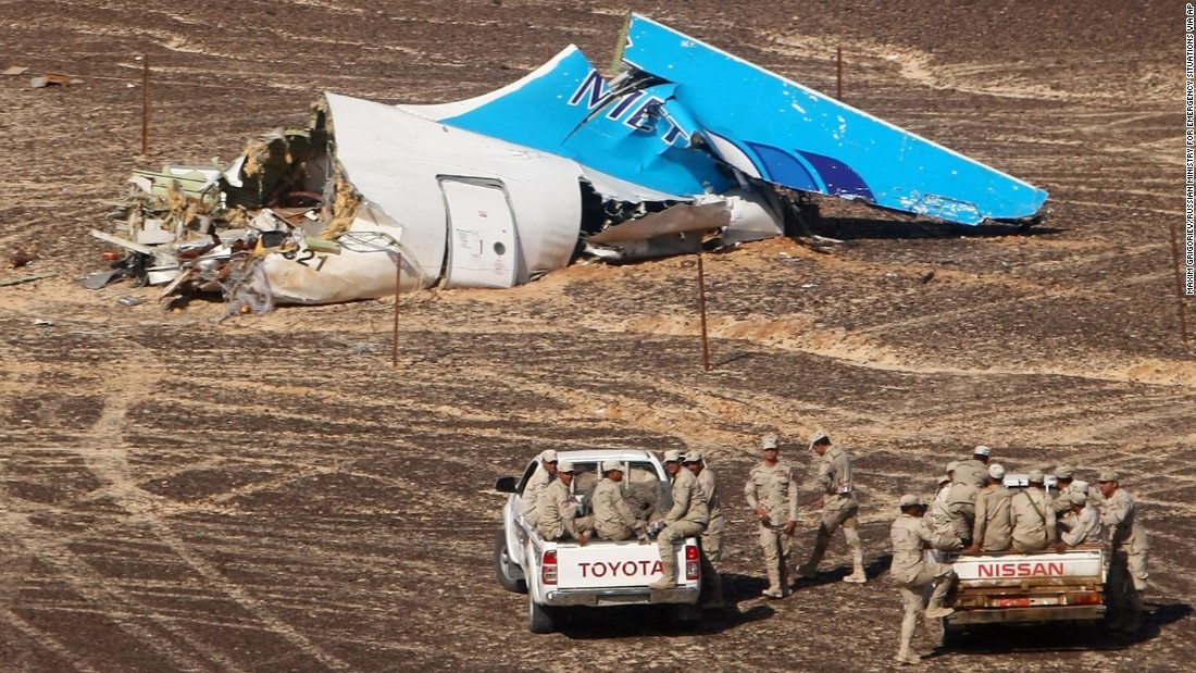 Egyptian military personnel stand near the tail of the jet in Hassana on Sunday, November 1.