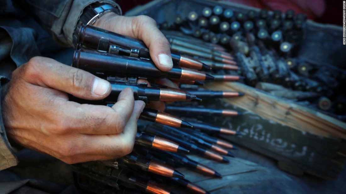 An Iraqi Kurdish Peshmerga fighter prepares an ammunition belt as he guards a position at the frontline of fighting against ISIS militants near the northern Iraqi town of Sinjar. 