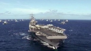 U.S. aircraft carrier stalked by submarine