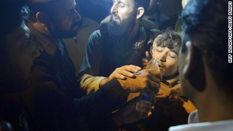Pakistani rescuers give water to a survivor from a collapsed factory on the outskirts of Lahore on Thursday. 