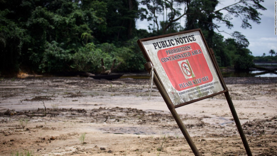 A sign warns people to stay off land contaminated by oil pollution.  