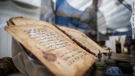 A 750 year old Koran is on show at an annual three-day event for members of the Ahmadiyya Muslim community known as the Jalsa Salana, in Hampshire on August 21, 2015. Over thirty thousand people are expected to attend, culminating in a pledge of allegiance to the Caliph on Sunday. Now in it&#39;s 49th year, Muslims from around 100 countries will attend the Jalsa Salana to listen to speeches by the Caliph. 
AFP PHOTO/Leon Neal        (Photo credit should read LEON NEAL/AFP/Getty Images)