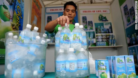 This photo taken on August 30, 2012 shows a vendor displaying coconut water products during the 26th National Coconut Week Celebration at the Philippine Coconut Authority building in Manila. After centuries of replenishing Filipinos, the mineral-rich liquid of coconut water has become a must-have health drink thanks to aggressive marketing by a beverage industry looking to offset soda sales that have lost their fizz. 