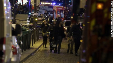 Security moves people along Rue Bichat following a string of attacks in the French capital Paris on November 13, 2015. At least 18 people were killed as multiple shootings and explosions hit Paris Friday, police said. Police also said there was an ongoing hostage crisis in the Bataclan a concert hall in the French capital. AFP PHOTO / KENZO TRIBOUILLARDKENZO TRIBOUILLARD/AFP/Getty Images