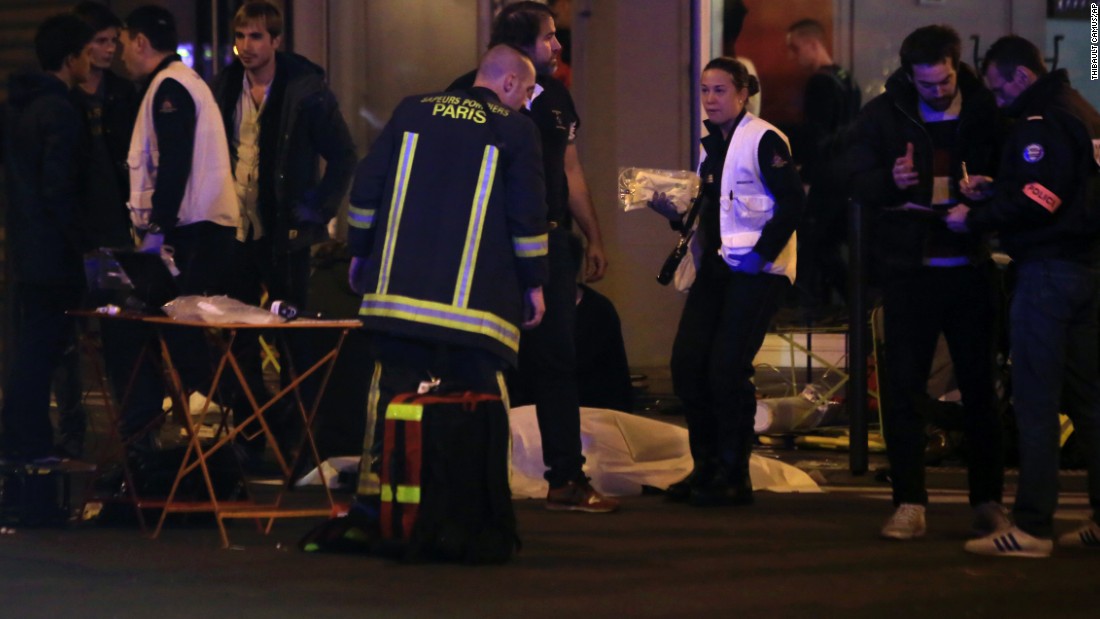 Rescue workers and medics tend to victims at the scene of one of the shootings, a restaurant in the 10th District. Attackers reportedly used AK-47 automatic weapons in separate attacks across Paris, and there were explosions at the Stade de France.