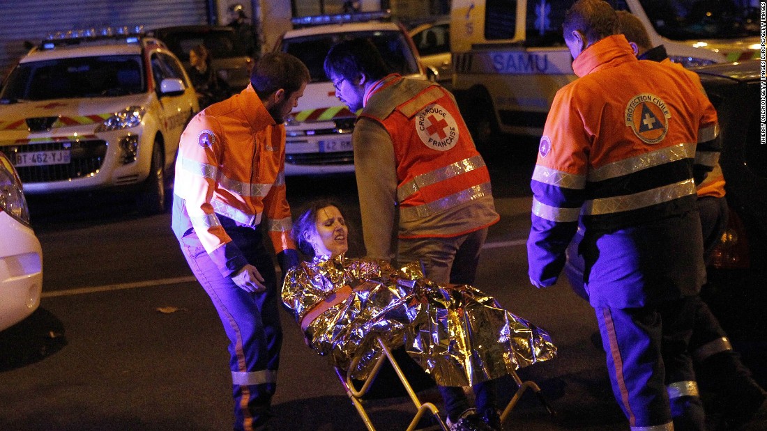 Medics evacuate an injured woman on Boulevard des Filles du Calvaire near the Bataclan early on November 14.