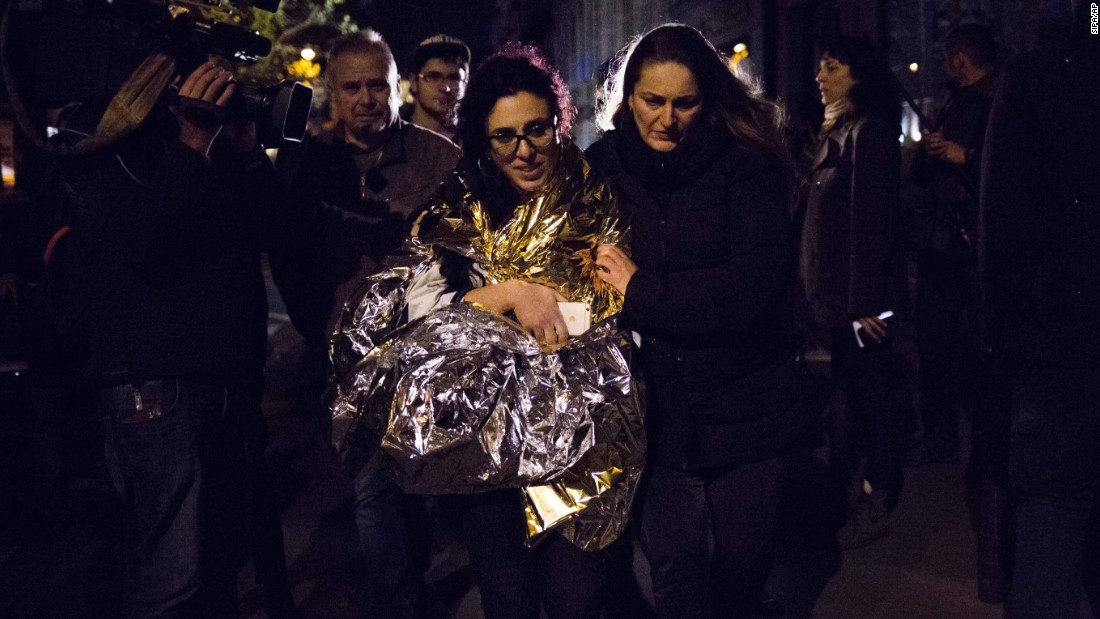 A survivor of the terrorist attack in the Bataclan is assisted following terror attacks, November 13. The violence at the Bataclan, which involved a hostage-taking, resulted in the highest number of casualties of all the attacks.