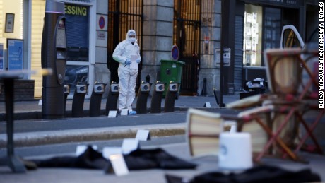 A forensic scientist inspects outside of the Cafe Bonne Biere on Rue du Faubourg du Temple in Paris on November 14, following a series of coordinated attacks in and around Paris late Friday, which left more than 120 people dead. According to witnesses, at least 5 people were killed in the immediate area by attackers wielding automatic rifles.      