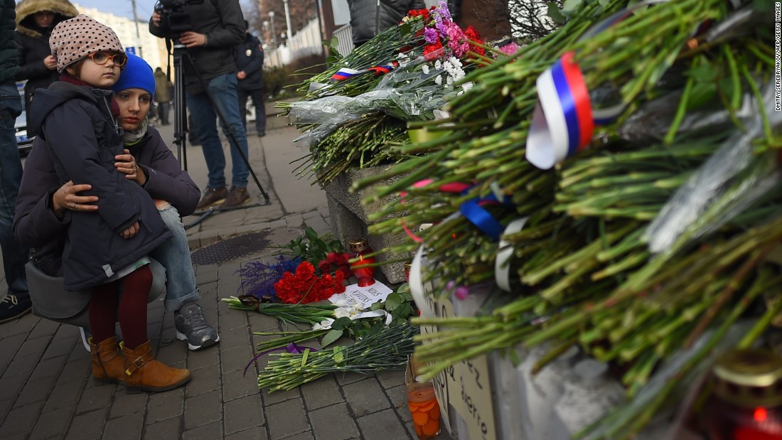 People lay flowers outside the French Embassy in Moscow on November 14.