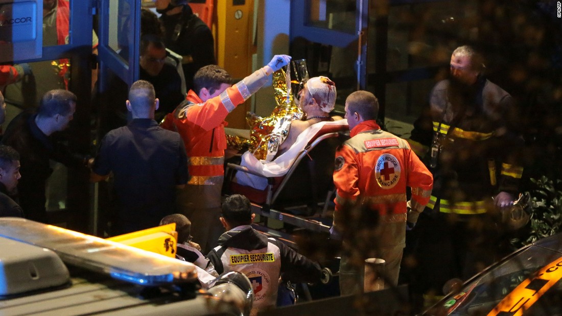 Rescuers evacuate an injured person near the Stade de France, one of several sites of attacks November 13 in Paris. Thousands of fans were watching a soccer match between France and Germany when the attacks occurred.