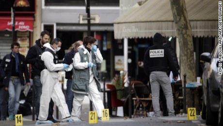 Forensic scientists inspect the Cafe Bonne Biere on Rue du Faubourg du Temple in Paris on Saturday, November 14 following a series of coordinated attacks in and around Paris late Friday.