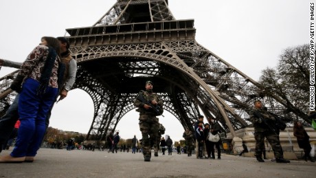 French soldiers patrol the area at the foot of the Eiffel Tower in Paris on November 14, 2015 following a series of coordinated attacks in and around Paris late Friday.