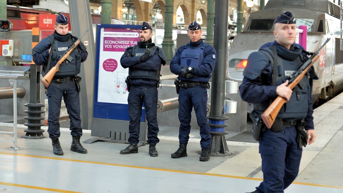 Police stand guard at a train station in Paris on November 14.