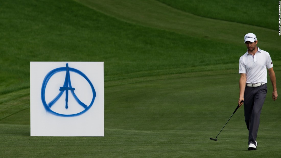 French golfer Gregory Bourdy passes a peace symbol for the Paris victims during the BMW Shanghai Masters tournament November 15 in Shanghai, China. 