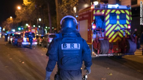 An elite police officer arrivesoutside the Bataclan theater  in Paris, France, Wednesday, Nov. 13, 2015. Several dozen people were killed in a series of unprecedented attacks around Paris on Friday, French President Francois Hollande said, announcing that he was closing the country&#39;s borders and declaring a state of emergency. (AP Photo/Kamil Zihnioglu)