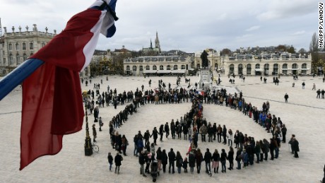 Image #: 40829488    Nancy 14 November 2015 - In the wake of deadly terrorist attacks in Paris, a human chain of 300 people formed the symbol of peace on the Place Stanislas in honor of the 128 victims and 300 injured.   Maxppp /Landov