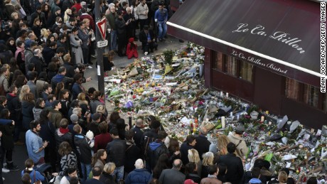 People gather at a makeshift memorial in front of &quot;Le carillon&quot; restaurant on November 16, 2015, in the 10th district of Paris, following a series of coordinated terrorists attacks on November 13. Islamic State jihadists claimed a series of coordinated attacks by gunmen and suicide bombers in Paris that killed at least 128 people in scenes of carnage at a concert hall, restaurants and the national stadium. AFP PHOTO / ALAIN JOCARD        (Photo credit should read ALAIN JOCARD/AFP/Getty Images)