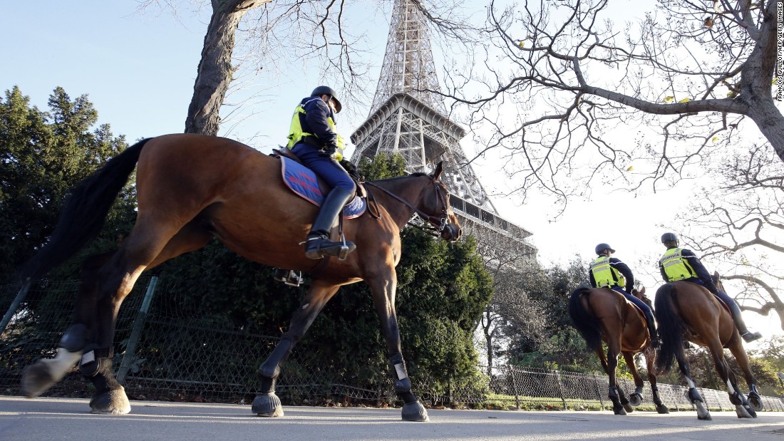 Mounted police officers patrol in front of the Eiffel Tower in Paris on November 15. 