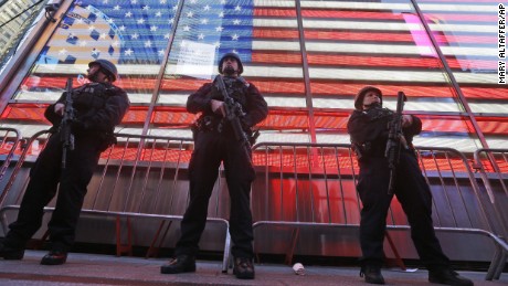 Heavily armed New York city police officers with the Strategic Response Group stand guard at the armed forces recruiting center in New York&#39;s Times Square, Saturday, Nov. 14, 2015.  Police in New York say they&#39;ve deployed extra units to crowded areas of the city &quot;out of an abundance of caution&quot; in the wake of the attacks in Paris, France. A New York Police Department statement released Friday stressed police have &quot;no indication that the attack has any nexus to New York City.&quot; (AP Photo/Mary Altaffer)