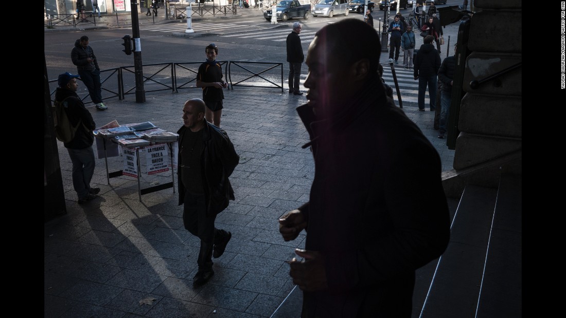 A man sells newspapers on Sunday, November 15, at the Barbes-Rochechouart Metro station in one of the Paris neighborhoods with the highest foreign-born population. The headlines read &quot;The War against Daech / ISIS&quot; and &quot;The Day After.&quot; 