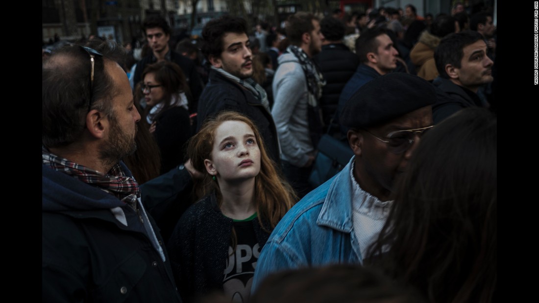 A crowd gathers on Rue Charonne on November 15 near the site of one of the attacks.