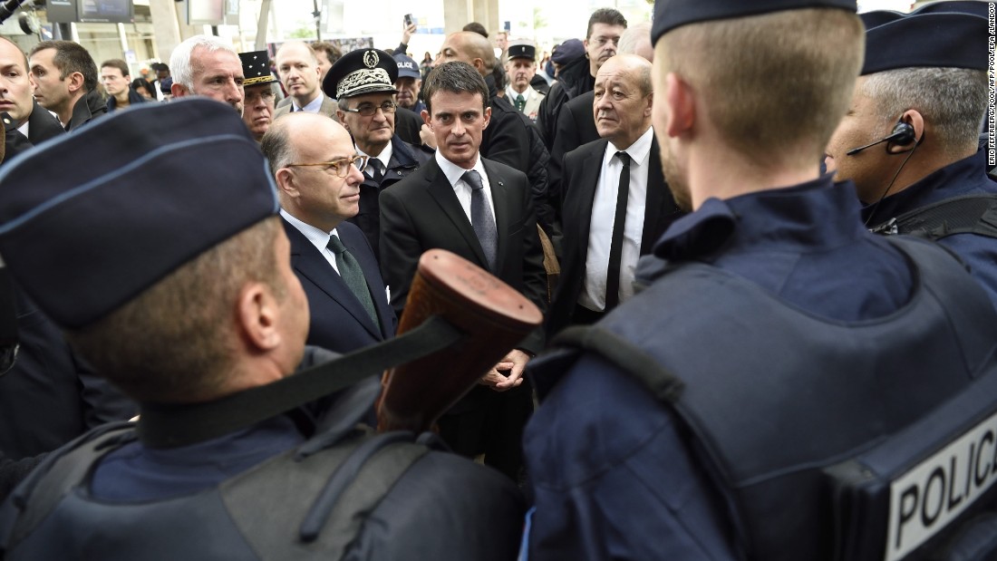 French Prime Minister Manuel Valls, center, speaks with police forces with French Interior minister Bernard Cazeneuve, left, and Defence Minister Jean-Yves Le Drian at the Gare du Nord railway station in Paris on November 15 about security measures after the attacks.