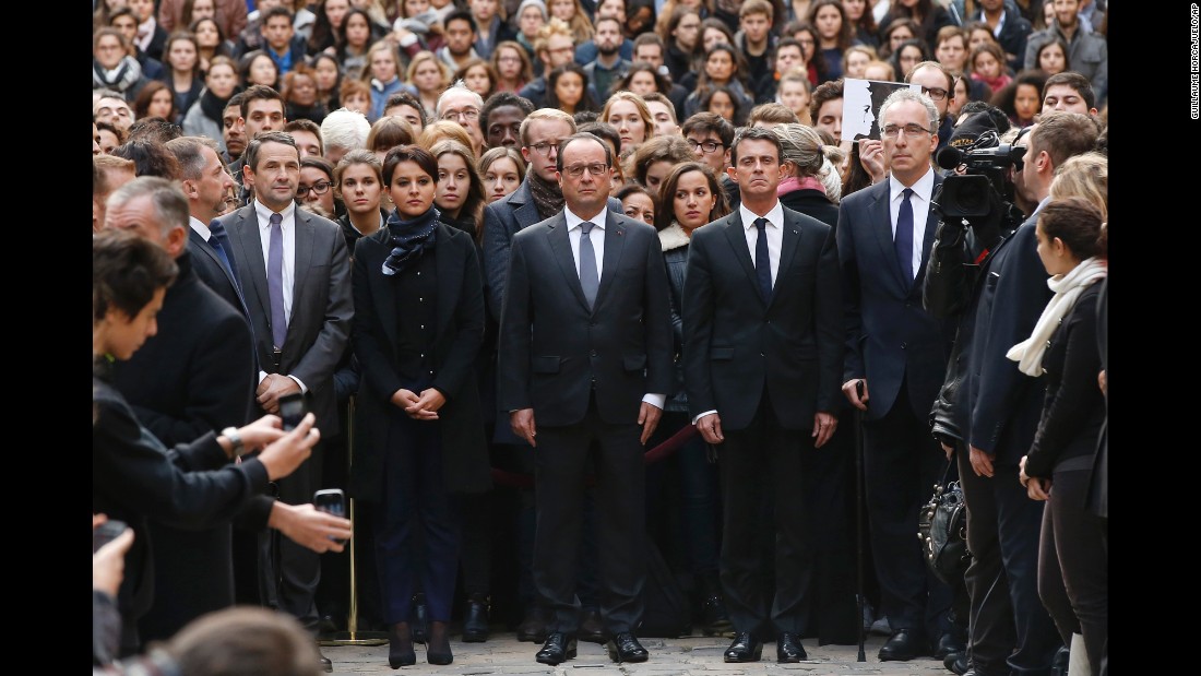 French President Francois Hollande, center, flanked by French Prime Minister Manuel Valls, right, and French Education Minister Najat Vallaud-Belkacem, center left, stands among students during a minute of silence in the courtyard of the Sorbonne University in Paris on November 16.