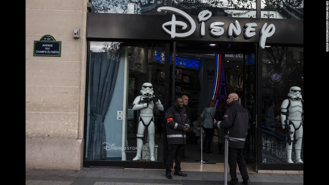 Security guards stand outside a Disney store on Champs Elysees in Paris on November 16. 
